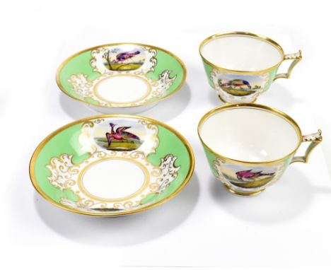 WORCESTER; a pair of Flight, Barr & Barr cups and saucers with apple green ground and oval vignette decorated with exotic bir