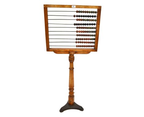 An early 20th century fruitwood framed abacus, terminating on a metal tripod base, impressed S.E.C, height 134.5cm.