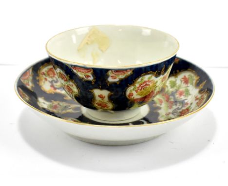 WORCESTER; an 18th century first period tea bowl and saucer decorated in the 'Wheat Sheaf' pattern, with blue scale ground, b