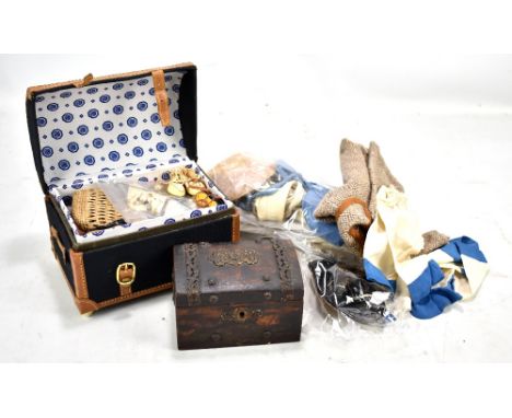 A group of early 20th century doll's clothing and accessories including hat, trunk containing several pairs of shoes, pair of