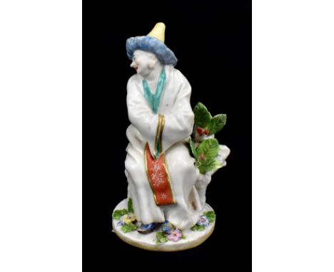 CHELSEA; a mid-18th century figure of a seated Chinese gentleman, painted red anchor mark to rear of base, height 11.5cm.Prov