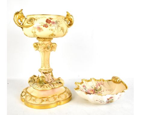 A large blush ivory twin handled vase on stand set with rams' heads and stylised dolphin supports to quatrefoil foot, puce pr