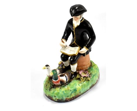 DERBY (Stevenson & Hancock); a late 19th century figure of Dr Syntax, seated sketching two ducks, painted marks to base, heig