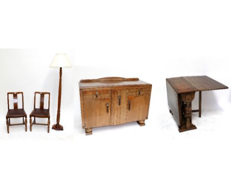 An oak dining room suite comprising a drop leaf table and four chairs, a matching sideboard, and a standard lamp (7).