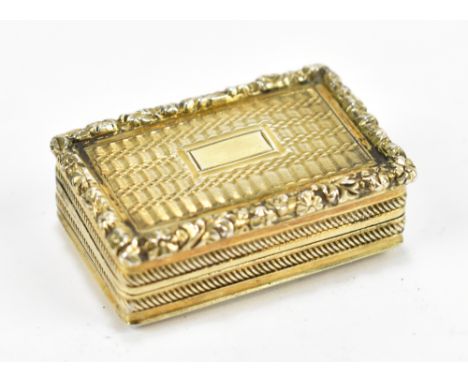 A George IV hallmarked silver pill box of rectangular form with gilt washed detail and foliate raised border, Thomas Parker, 