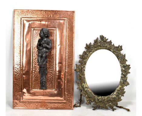 An oval mirror with cast iron foliate motif surround, 47 x 36cm, and a rectangular beaten copper plaque (2).