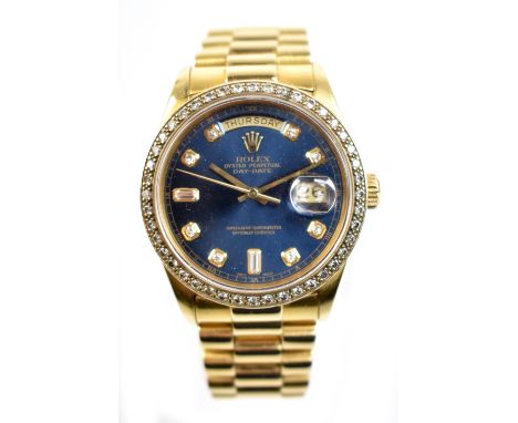 ROLEX; an 18ct gold Day Date wristwatch, the bezel set with diamonds and dial with diamond numerals, with blue face, diameter