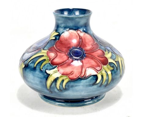 MOORCROFT; a squat vase decorated in the 'Anemone' pattern on a blue ground, original paper label and impressed factory marks