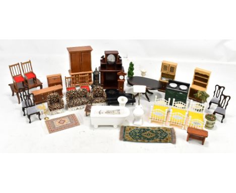 A mixed group of dolls house furniture including ceramic bath with gilt taps, toilet and sink, beds, three piece suite and fu