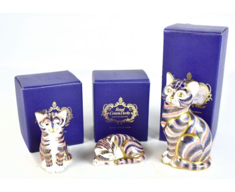 ROYAL CROWN DERBY; three animal form paperweights, modelled as cats, with silver base buttons and original boxes.Additional I