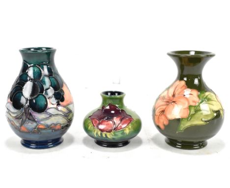 MOORCROFT; three vases, to include a&nbsp;'Hibiscus' pattern example on a green ground, height 30cm, and&nbsp;an 'Anemone' sq