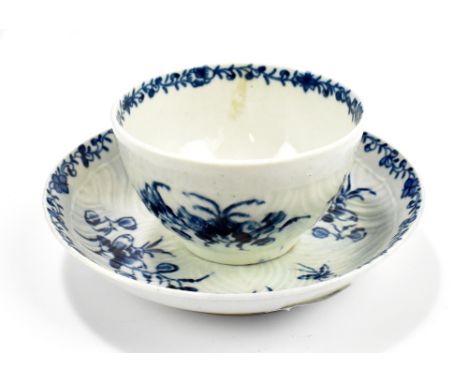 WORCESTER; an 18th century first period feather moulded tea bowl and saucer decorated with floral sprays, diameter of saucer 