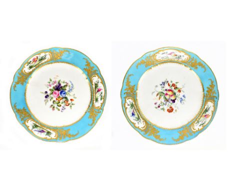 SEVRES; a pair of 18th century cabinet plates with Bleu Celeste border, cisele gilding and centred with fruits and flowers wi