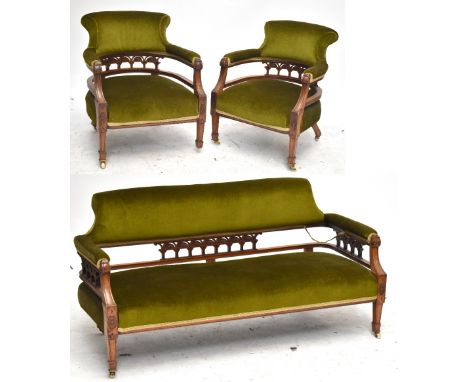 An Edwardian line inlaid oak three piece salon suite comprising three seater sofa and two tub armchairs.