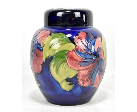 WALTER MOORCROFT; a ginger jar and cover, decorated in the 'Hibiscus' pattern on a blue ground, blue signature and original p