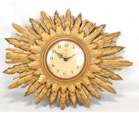 SMITHS SECTRIC; a gilt framed sun burst wall clock set with Arabic numerals, width 61cm.