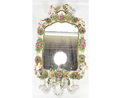 SITZENDORF; an ornate ceramic framed three branch girandole mirror decorated with cherubs and moulded flowers throughout, app