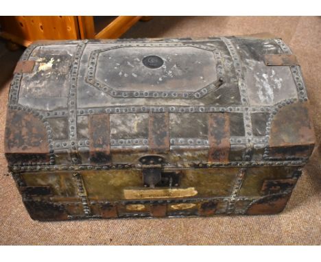A 19th century dome topped trunk with applied metal corners and studwork, with pony skin body, central plaque with initials C