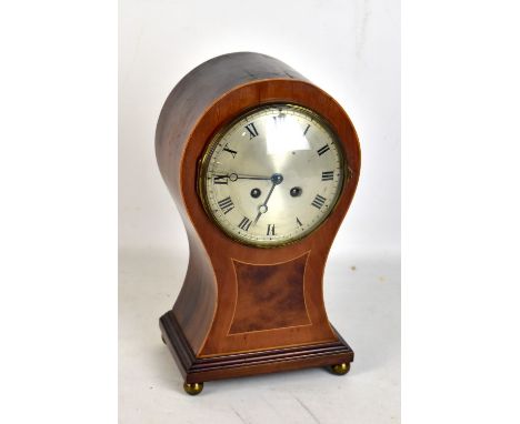 An Edwardian mahogany and boxwood strung balloon shaped mantel clock with silvered dial set with Roman numerals and with Japy