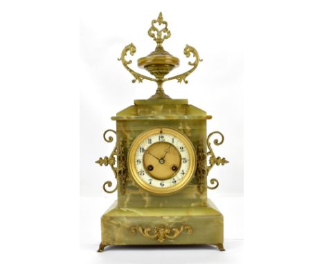 An early 20th century onyx mantel clock, with gilt metal applied urn finial and handles, the circular dial with Arabic numera