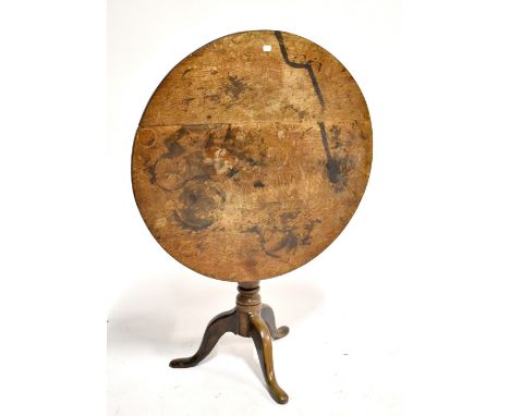 A George III oak tilt top tripod table, diameter 77cm.Additional InformationTop heavily worn, stains, discoloured. The entire