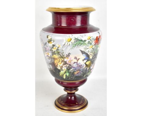 A large late 19th century Continental porcelain vase decorated with a continuous band with a blue tit amongst branches and fl