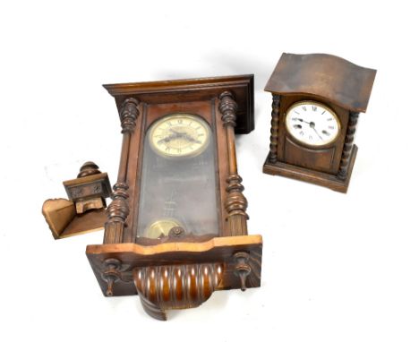 An oak mantel clock, the circular dial set with Roman numerals, and a wall clock (af) (2).