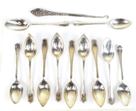 Eleven George V hallmarked silver grapefruit and teaspoons, Sheffield 1931, approx 7.8ozt, also a silver sheath handled steel