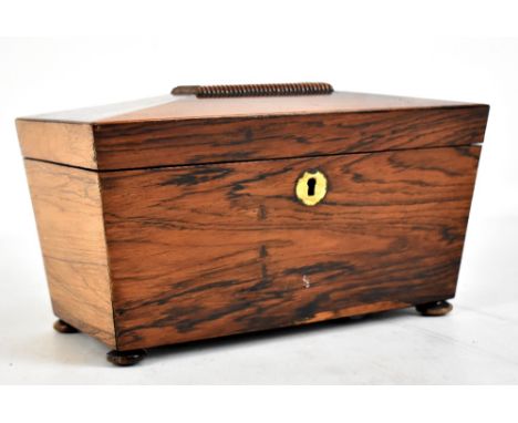 A 19th century rosewood tea caddy, the hinged cover enclosing two lidded compartments and raised on bun feet, length 25cm.