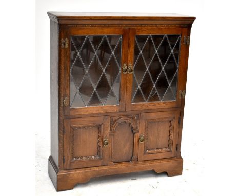 An oak side cabinet with twin glazed doors enclosing single shelf above twin cupboard doors, 103 x 84cm.Additional Informatio