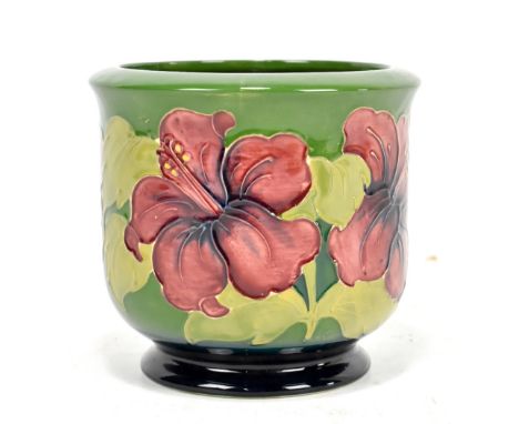 MOORCROFT; a jardinière of small proportions, decorated in the 'Hibiscus' pattern on a green ground, remains of original labe