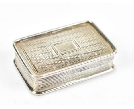 A William IV hallmarked silver vinaigrette of rounded rectangular form, with engraved cover and base and pierced grille conta