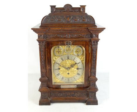 GURKHA INTEREST; a good and large late 19th century oak eight day mantel clock with carved case, arched dial set with silvere