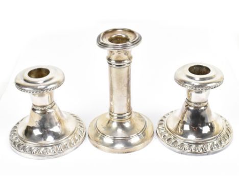 WILLIAM AITKEN; an Edward VII hallmarked silver candlestick, together with a pair of sterling silver squat form candlesticks 