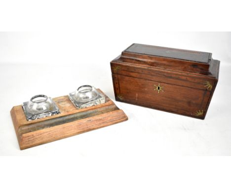 An early 19th century rosewood and brass inlaid sarcophagus tea caddy, width 31.5cm (af), and a simple oak inkwell with two g