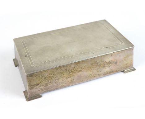 BROOK &amp; SON; a George V hallmarked silver cigarette box, the hinged cover with engine turned decoration and raised on fou