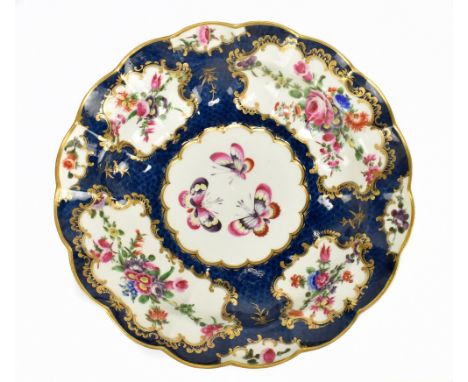 WORCESTER; an 18th century shaped bowl with blue scale ground and shaped vignettes decorated with butterflies and floral spra