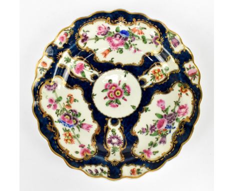 WORCESTER; an 18th century small shaped bowl with blue scale ground and shaped vignettes painted with floral sprays, painted 