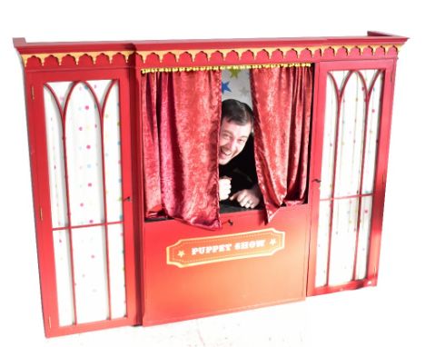 An upcycled red painted dresser top made into a puppet show booth.Additional InformationNo puppets included.