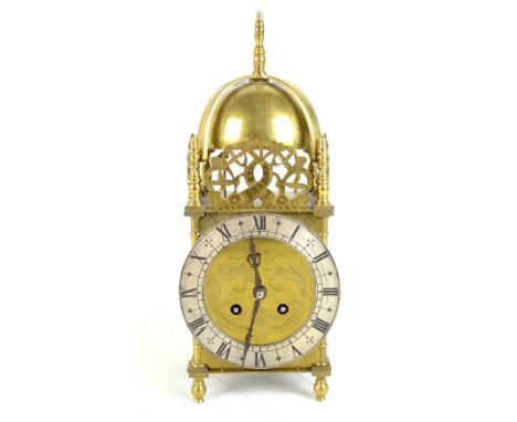 An early 20th century French brass cased lantern clock of typical form, with three pierced brass galleries above circular sil