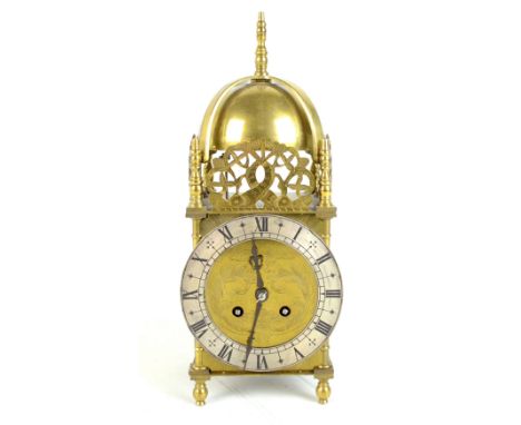 An early 20th century French brass cased lantern clock of typical form, with three pierced brass galleries above circular sil