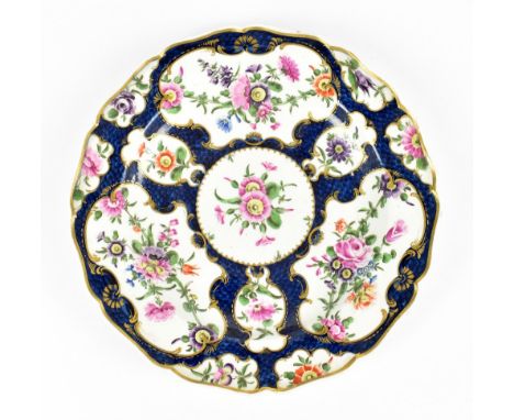 WORCESTER; an 18th century first period plate painted with blue scale ground and vignette painted with floral sprays, painted