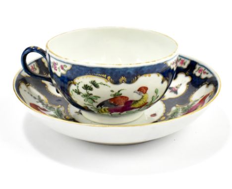 WORCESTER; an 18th century first period cup and saucer with blue scale ground and vignette panels decorated with exotic birds