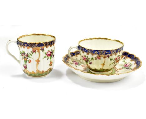 WORCESTER; an 18th century first period trio with sea green and blue and gold borders and painted with floral sprays, compris