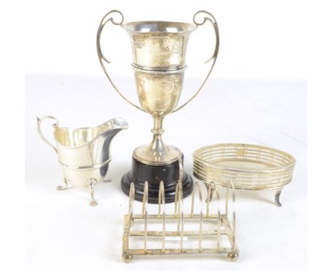 Four pieces of hallmarked silver including a twin handled trophy cup, London 1921, Mappin &amp; Webb open salt, Chester cream