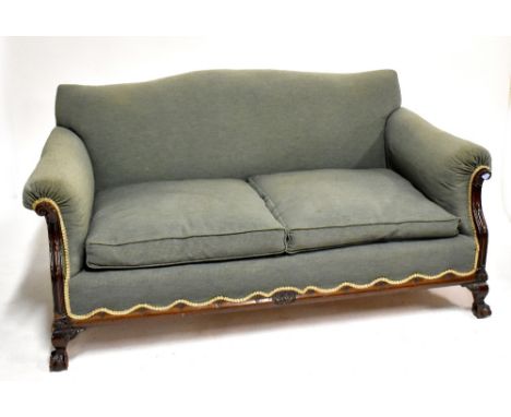 An early 20th century sofa raised on ball and claw feet, and with shaped back rail.