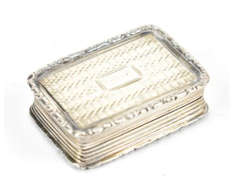 JOSEPH WILMORE; an early 19th century hallmarked silver vinaigrette of rounded rectangular form, with engraved cover, traces 