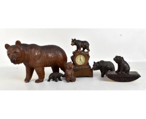 Six Black Forest carved wooden bears to include a figural clock, height 17cm, a desk blotter, etc (6).