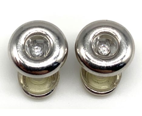 CHOPARD; a pair of 18ct white gold 'Happy Diamonds' ear clips, each approx 1.1cm diameter, approx 11g.