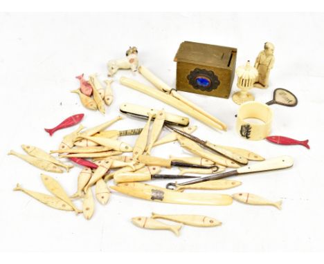 A collection of carved bone items including fish, miniature cricket bat, handled button hook, etc.
